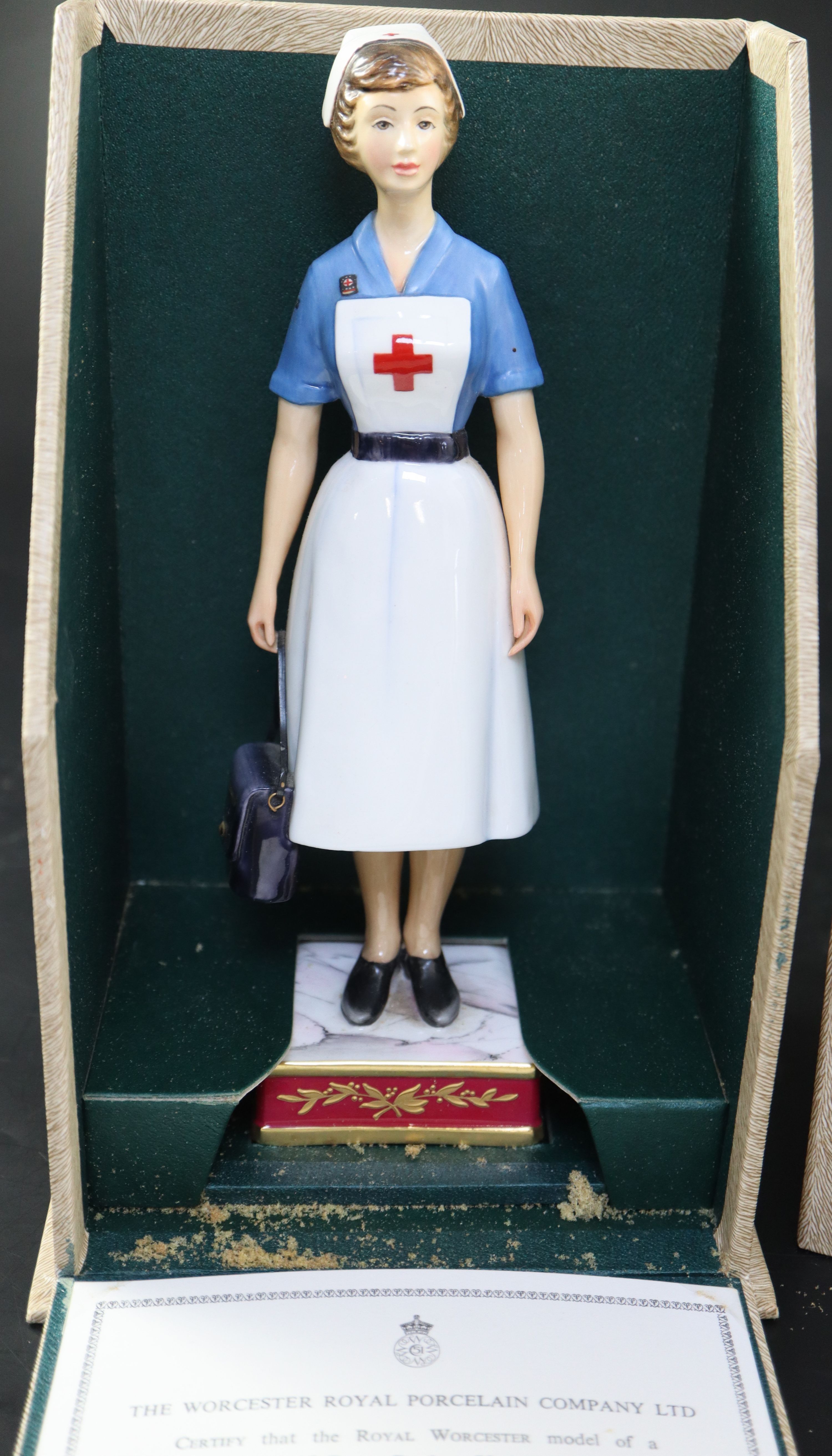 A Royal Worcester model of a British Red Cross Society V.A.D. Member, height 22cm